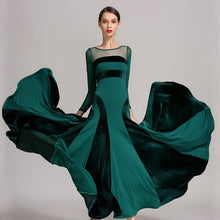 Load image into Gallery viewer, Woman in a flowing green dress with black panels
