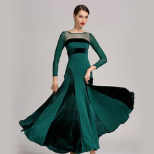 Load image into Gallery viewer, Woman in a flowing green and black dress, staring at the camera