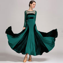 Load image into Gallery viewer, Woman wearing a flowing green and black dress
