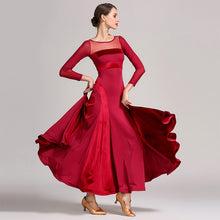 Load image into Gallery viewer, Woman in a red dress with her hands on her hips
